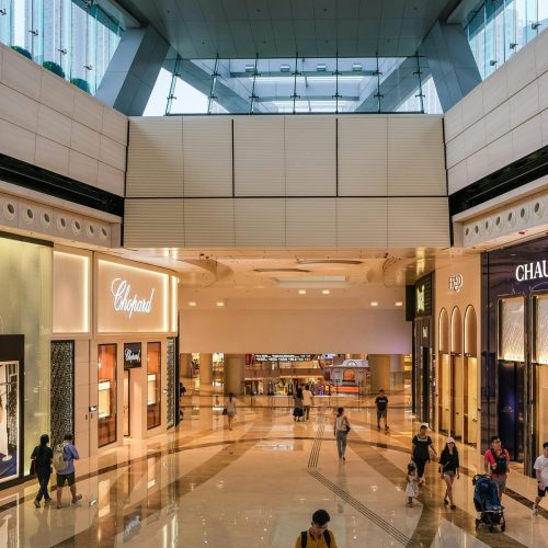 Explore the modern architecture of a luxury shopping mall in Hong Kong.