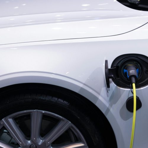 pexels-photo-3846205-3846205 A white electric car is plugged in for charging, close-up view of the charging port.